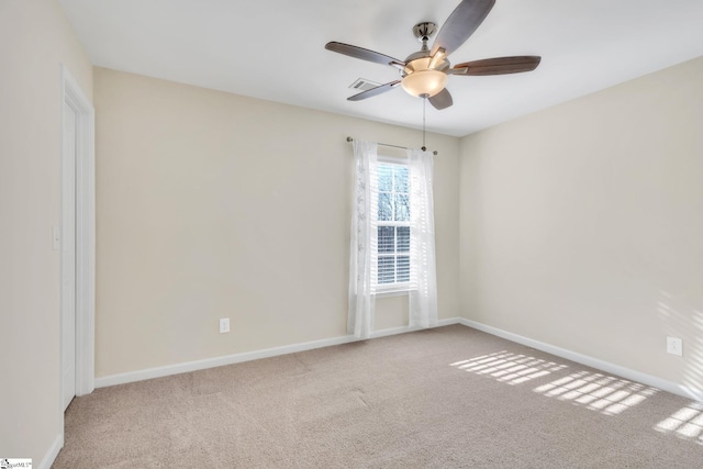 carpeted spare room with ceiling fan