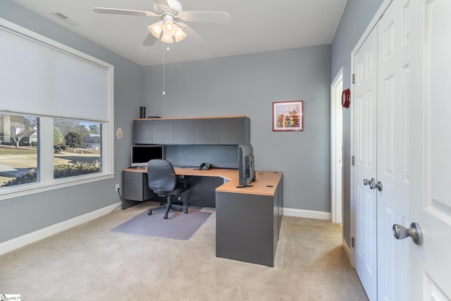 carpeted office featuring ceiling fan