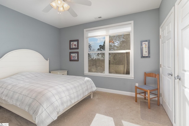 bedroom featuring light carpet and ceiling fan