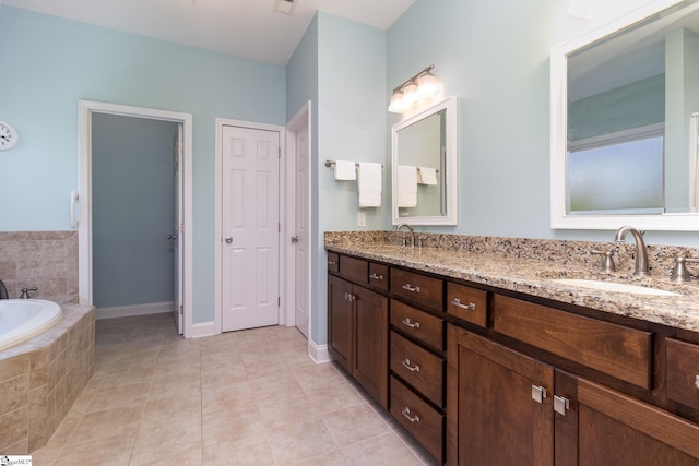 bathroom featuring a relaxing tiled tub, vanity, and tile patterned flooring