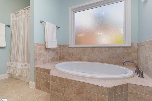 bathroom featuring tile patterned floors and tiled tub