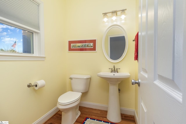 bathroom featuring sink, hardwood / wood-style flooring, and toilet