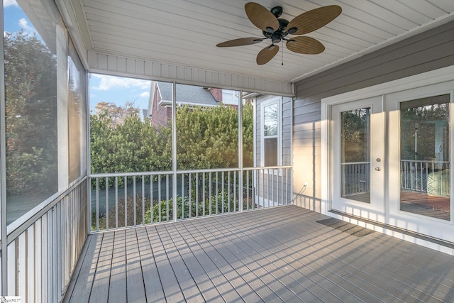 unfurnished sunroom with ceiling fan