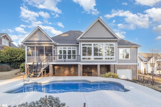 view of swimming pool with a sunroom