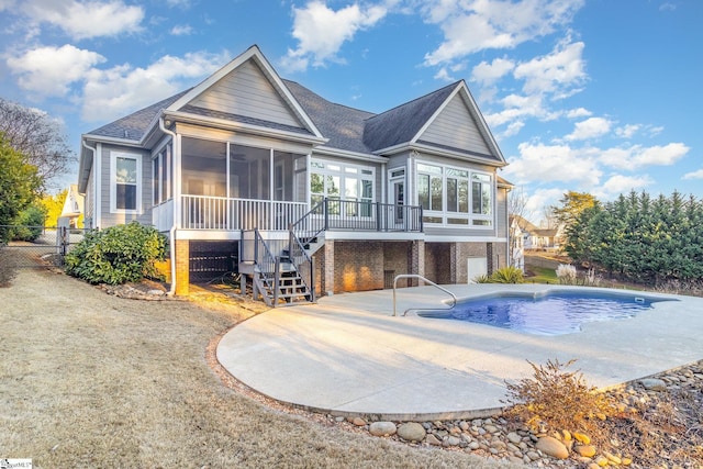 rear view of property with a patio and a sunroom