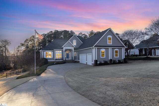 front of property with a garage and a yard