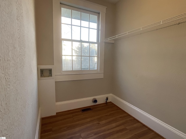 washroom featuring dark wood-type flooring and washer hookup