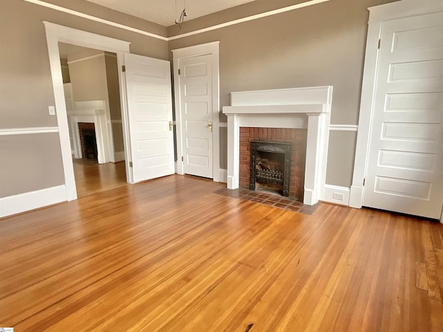 unfurnished living room with hardwood / wood-style flooring and a fireplace