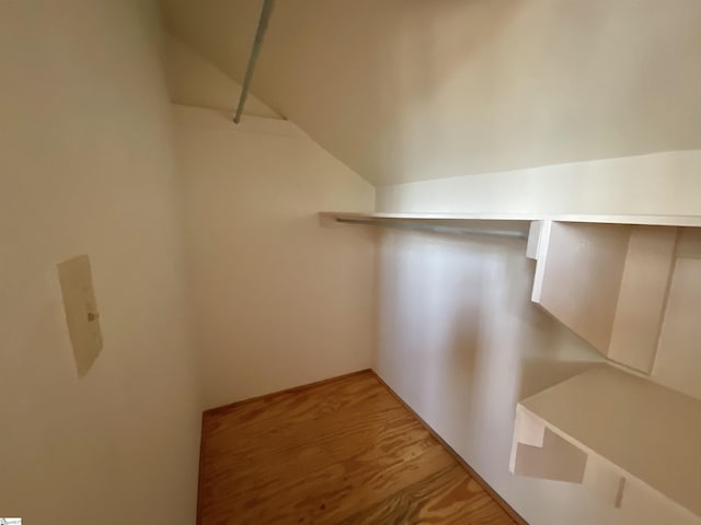 walk in closet featuring vaulted ceiling