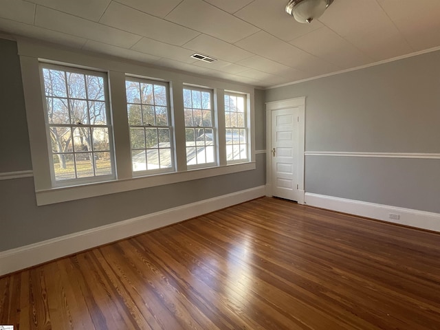 unfurnished room with hardwood / wood-style flooring and ornamental molding