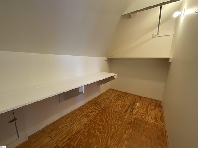 walk in closet with vaulted ceiling