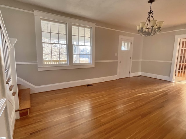 interior space featuring a notable chandelier and wood-type flooring