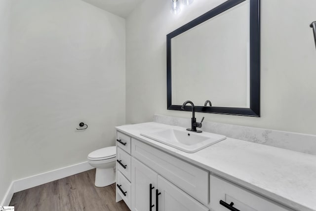 bathroom featuring vanity, toilet, and wood-type flooring