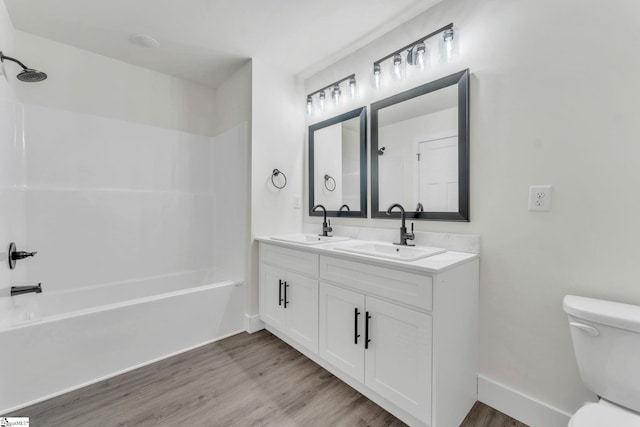 full bathroom with vanity, wood-type flooring, bathtub / shower combination, and toilet