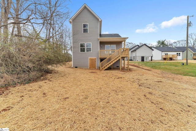 rear view of property with a wooden deck