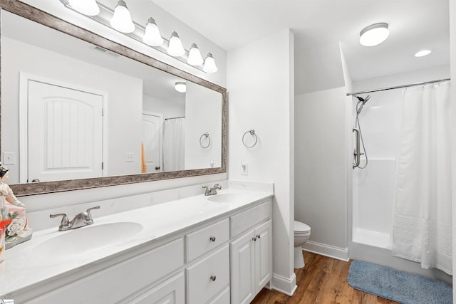 bathroom with vanity, hardwood / wood-style floors, and toilet