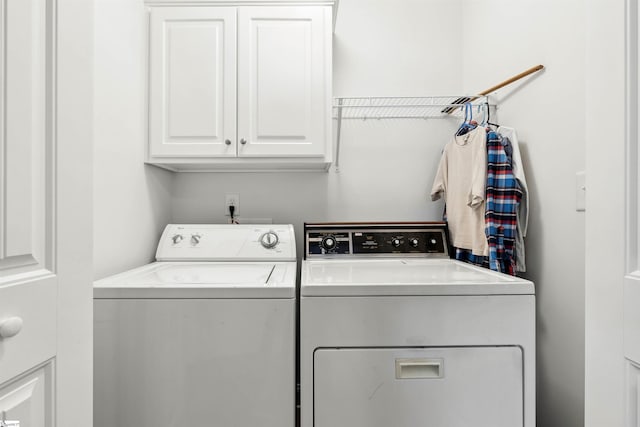 laundry area featuring cabinets and washing machine and clothes dryer