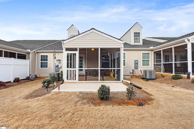 rear view of house featuring central AC unit, a patio area, and a sunroom