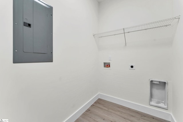 laundry room with hookup for a washing machine, wood-type flooring, electric panel, and hookup for an electric dryer