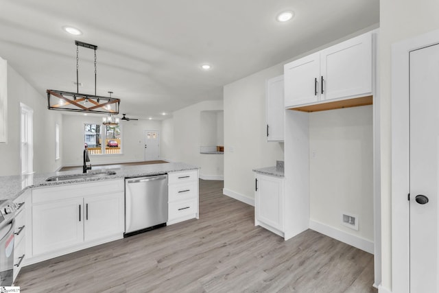 kitchen featuring decorative light fixtures, dishwasher, sink, and white cabinets