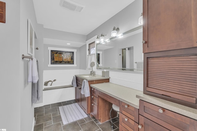 bathroom with vanity and tiled tub