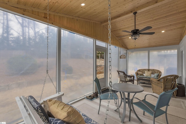 sunroom / solarium featuring vaulted ceiling, wooden ceiling, and ceiling fan