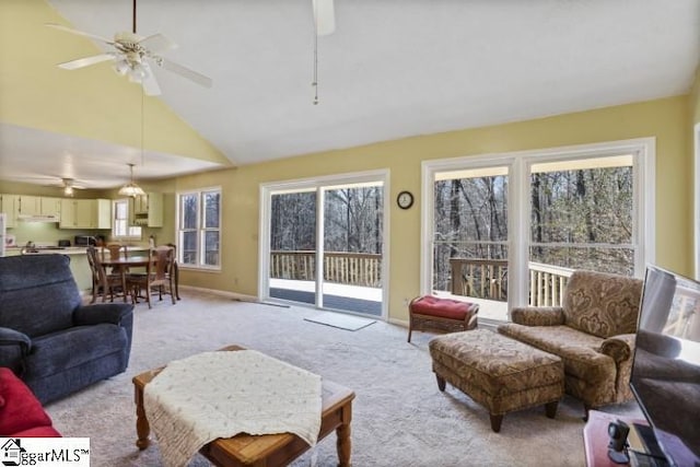 carpeted living room featuring high vaulted ceiling and ceiling fan