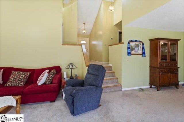 carpeted living room featuring a towering ceiling