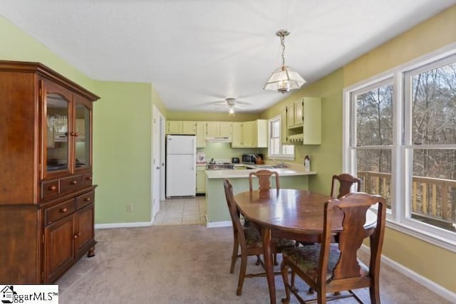 dining space featuring plenty of natural light and light colored carpet