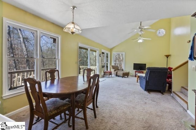 dining space with lofted ceiling and light carpet