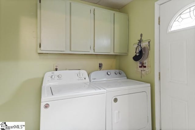 laundry area featuring cabinets and washing machine and clothes dryer