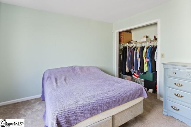 bedroom featuring light colored carpet and a closet