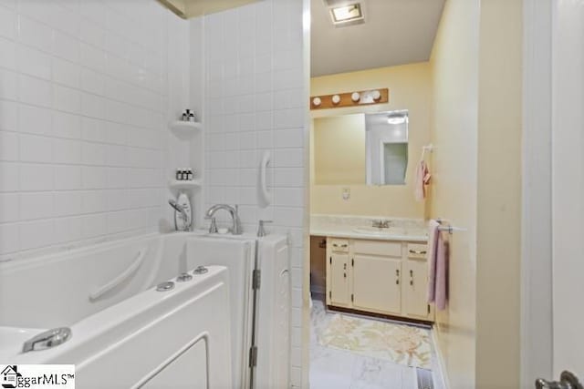 bathroom with vanity and a bathtub