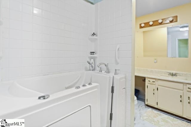 bathroom featuring vanity and a bath