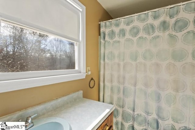 bathroom with vanity and walk in shower