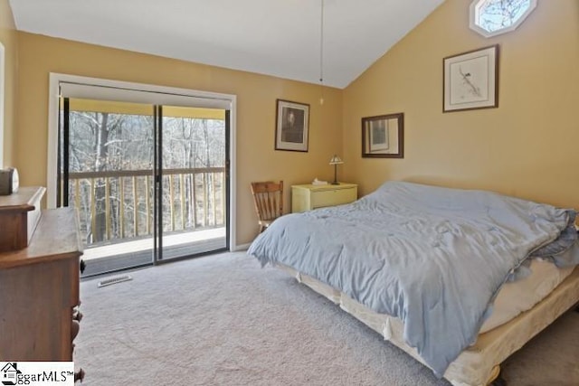 carpeted bedroom with access to outside and vaulted ceiling