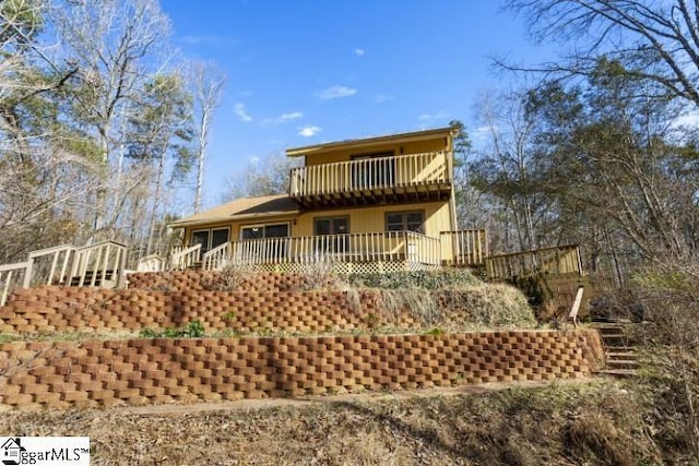 rear view of property featuring a deck