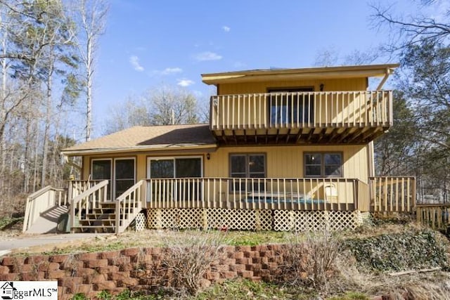 back of property featuring a deck