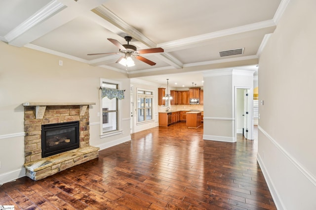 unfurnished living room featuring dark wood-type flooring, a fireplace, coffered ceiling, and beam ceiling