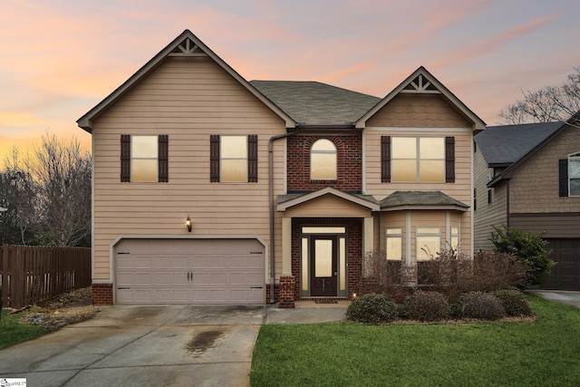 view of front of property featuring a garage and a yard