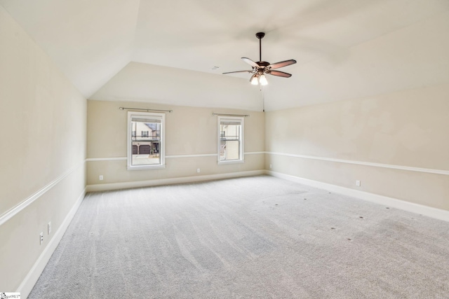 carpeted empty room featuring lofted ceiling and ceiling fan