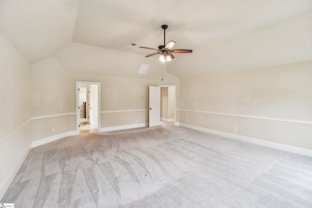 unfurnished room with lofted ceiling, light carpet, and ceiling fan