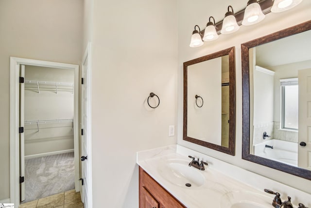 bathroom with vanity, a tub to relax in, and tile patterned floors