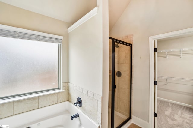 bathroom with separate shower and tub and lofted ceiling