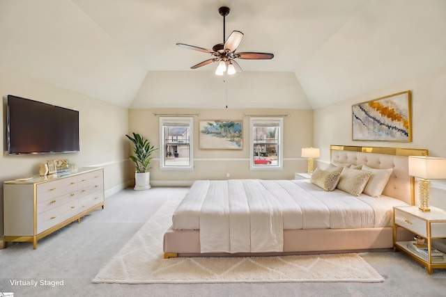 bedroom with light carpet, vaulted ceiling, and ceiling fan