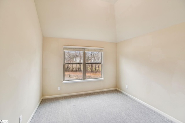 empty room featuring lofted ceiling and carpet floors