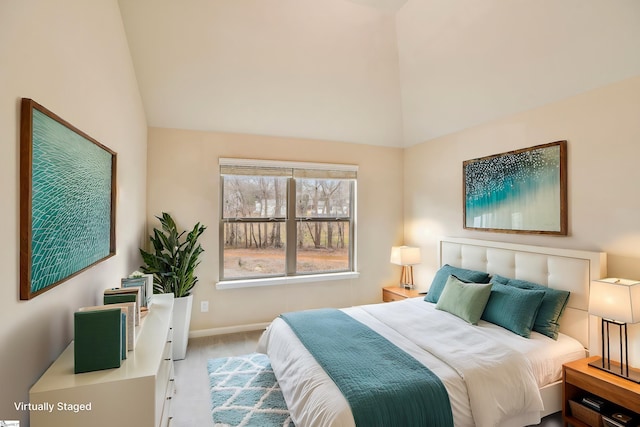 bedroom featuring vaulted ceiling and light colored carpet