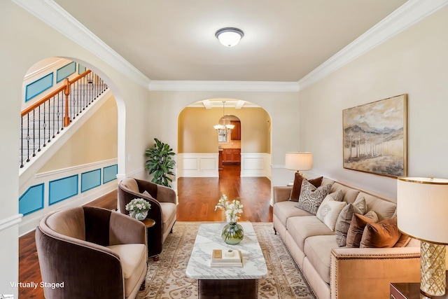 interior space with ornamental molding, a chandelier, and hardwood / wood-style floors