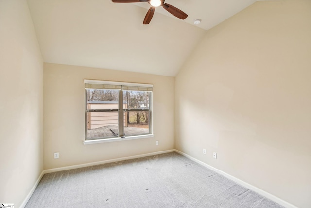 carpeted empty room featuring ceiling fan and vaulted ceiling