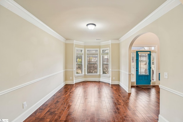 foyer entrance with crown molding and dark wood-type flooring